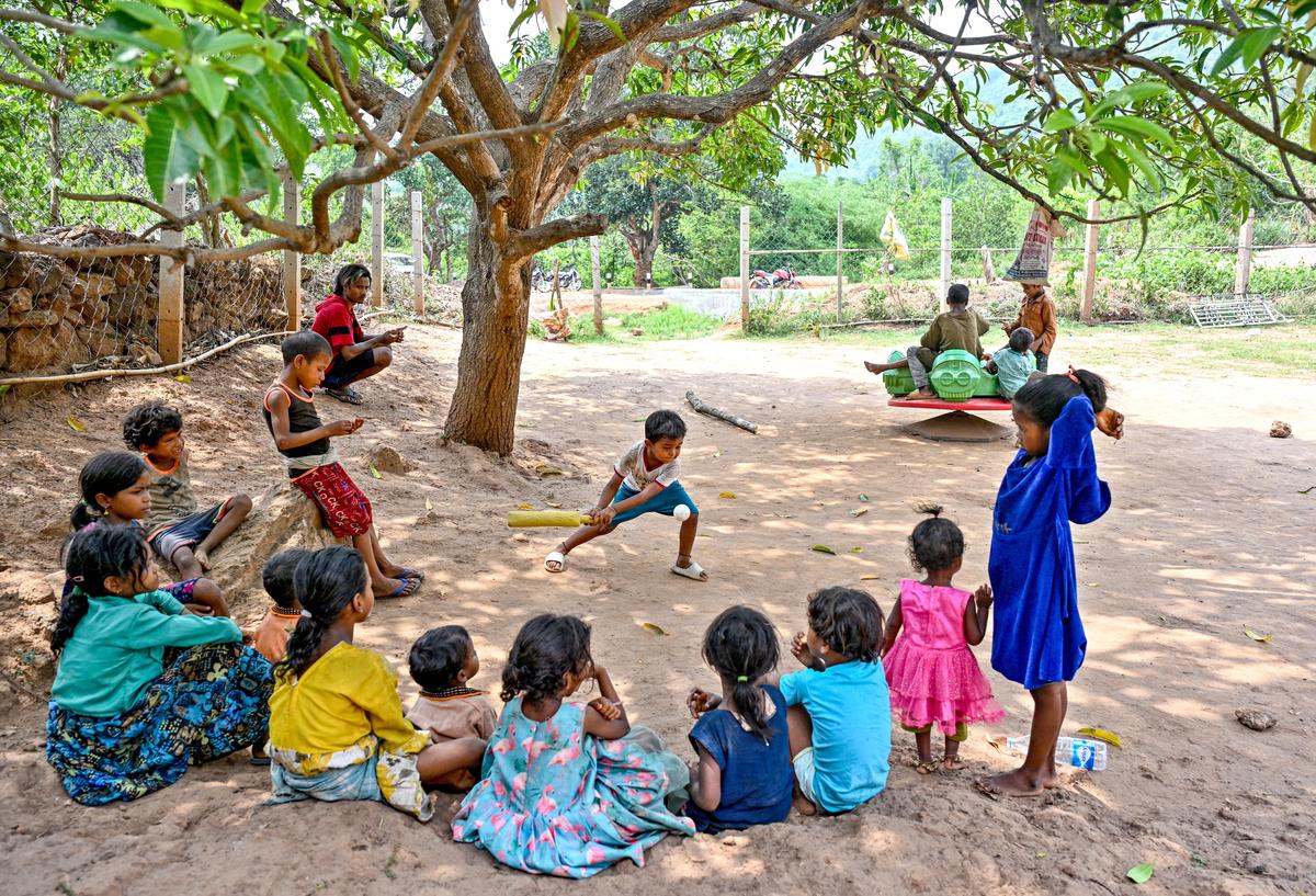 Children from Dongria Kondh tribe playing a game of cricket beneath a large tree in Phakeri village in Niyamgiri, Odisha.