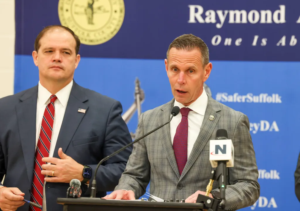 Suffolk County District Attorney Raymond A. Tierney speaking at a press conference next to Suffolk County Police Commissioner Kevin Catalina.