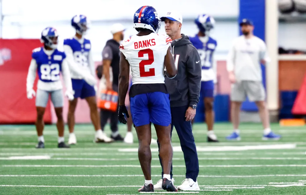 New York Giants cornerback Deonte Banks (2) talks to head coach John Harbaugh during football practice, Thursday, May 21, 2026, in East Rutherford, N.J.