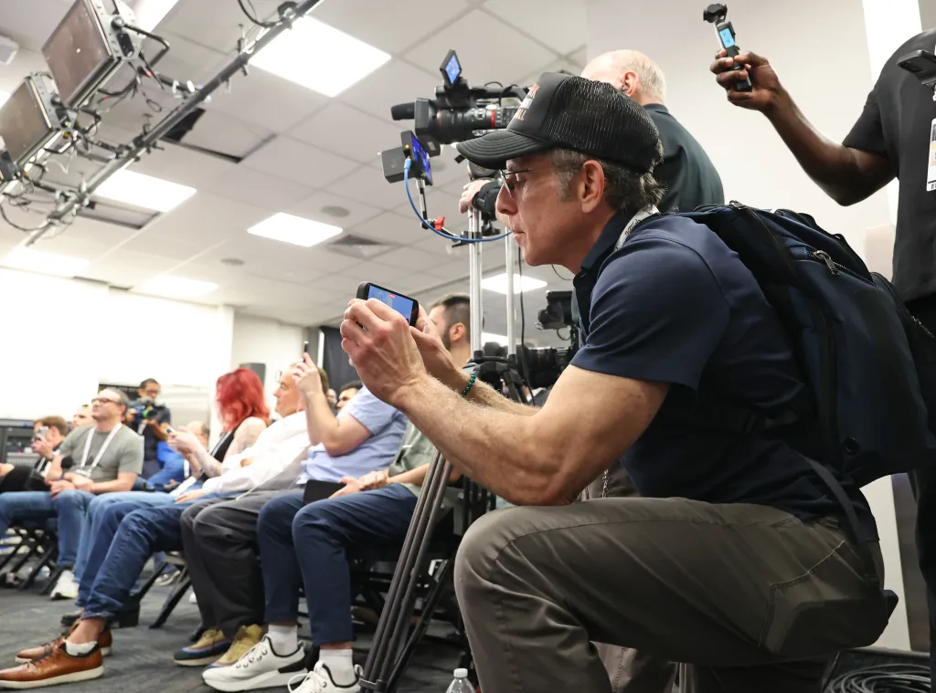 Ben Stiller filming New York Knicks guard Jalen Brunson's press conference at Madison Square Garden.