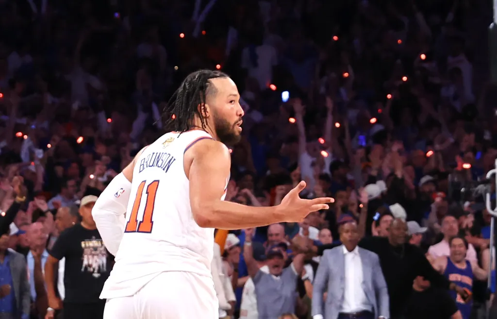 New York Knicks guard Jalen Brunson #11 reacts after he sinks a three-point shot over San Antonio Spurs forward Victor Wembanyama #1 to bring the Knicks within one during the fourth quarter of NBA Finals Game 4.