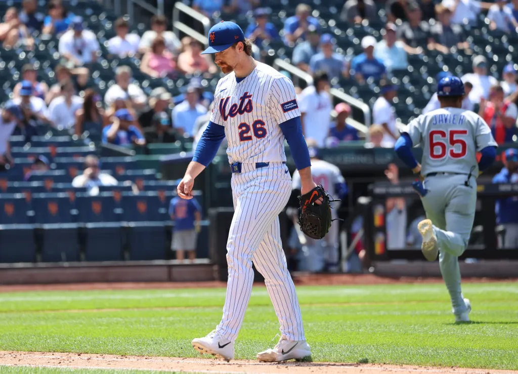 New York Mets pitcher Nolan McLean #26 reacts as he walks off the field after ending the sixth inning giving up a three-run home run.
