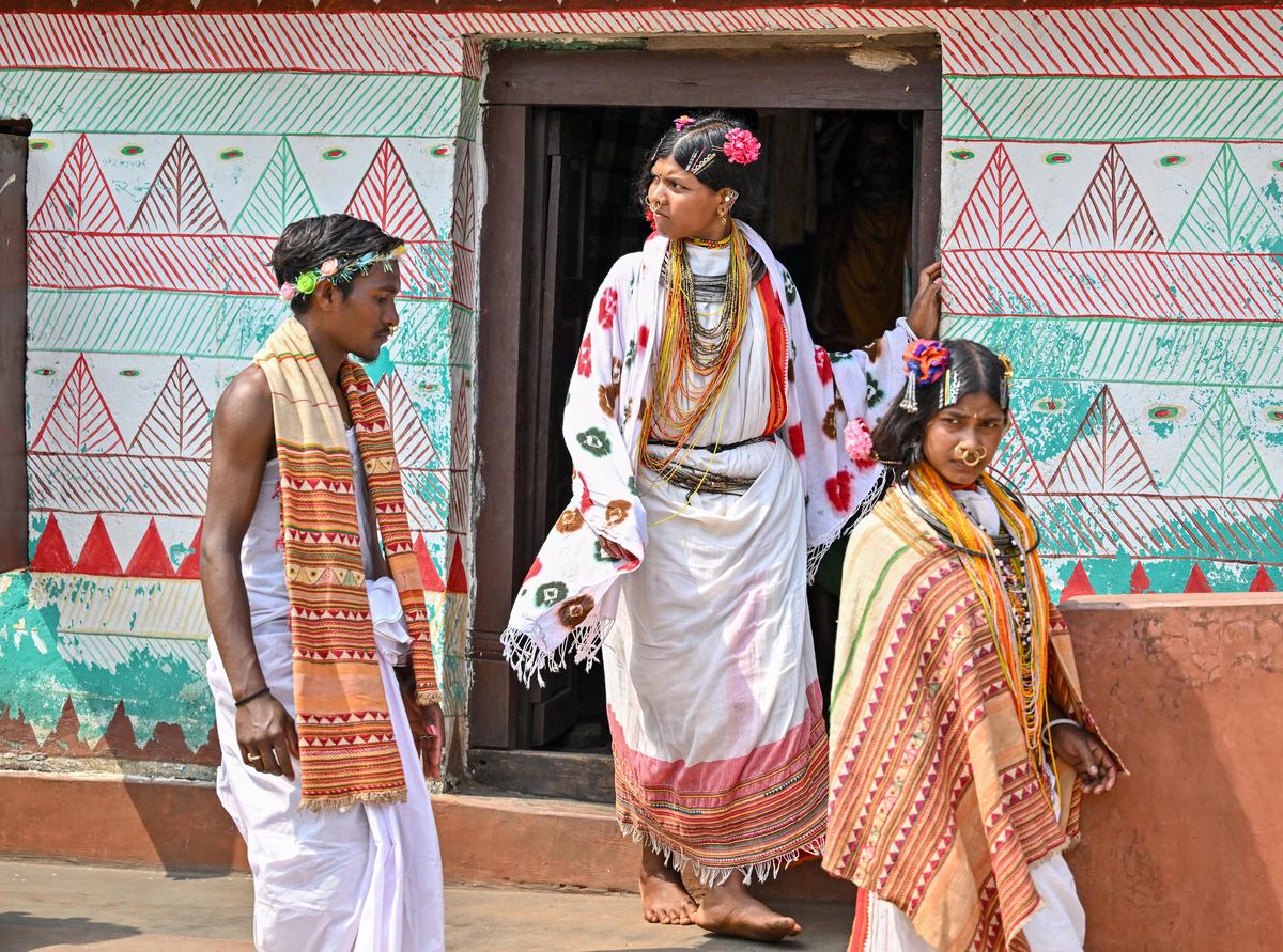 People from Dongria Kondh tribe stepping out of their homes in traditional wear for their village festival near Niyamgiri Hills of Odisha.