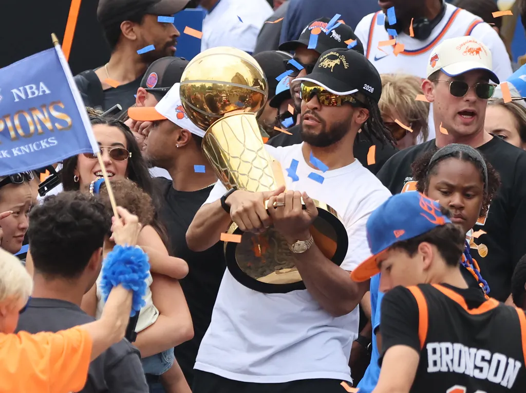 Jalen Brunson carries the Larry O'Brien trophy during the Knicks' championship parade on June 18, 2026.