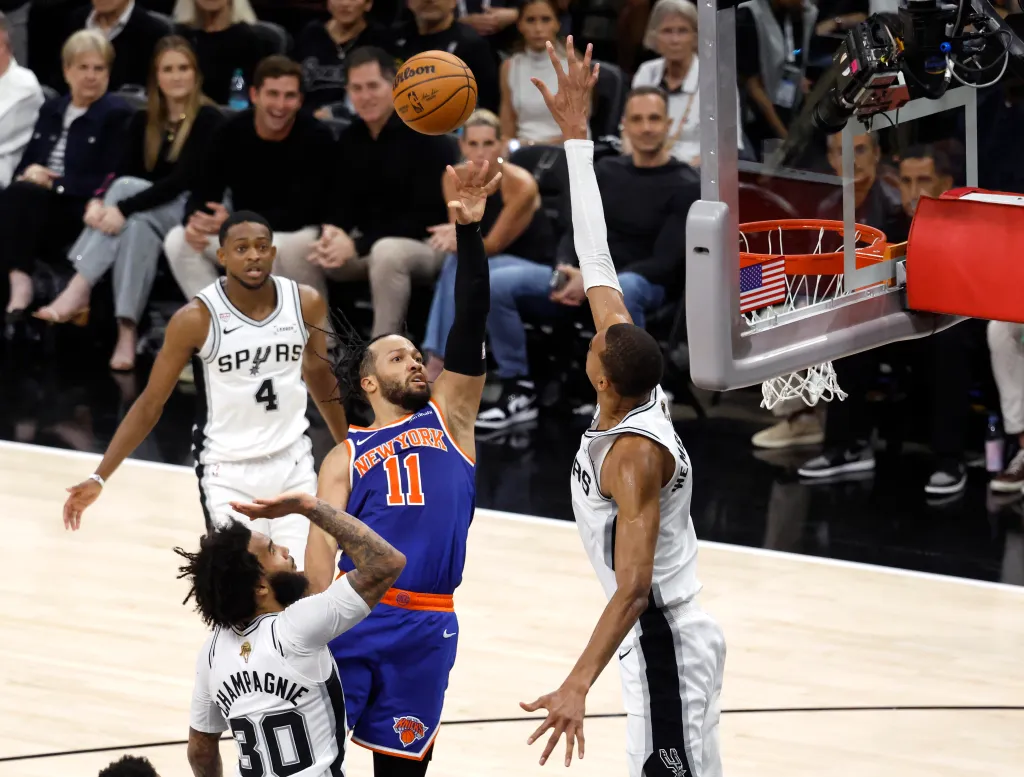 New York Knicks guard Jalen Brunson (11) shoots the ball while San Antonio Spurs forward Victor Wembanyama (1) defends.