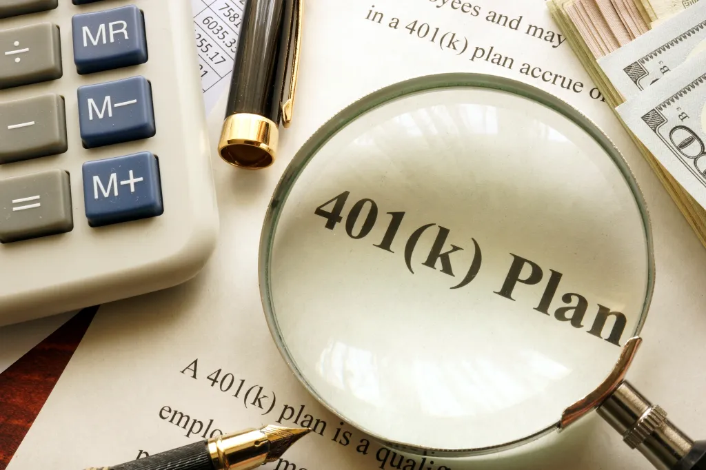 A magnifying glass over a document showing "401(k) Plan" with a calculator, pen, and money in the background.