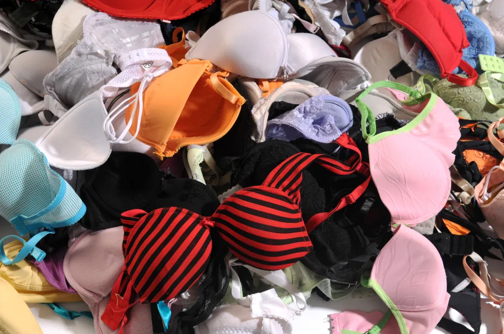 A pile of multi-colored bras in various sizes and styles.