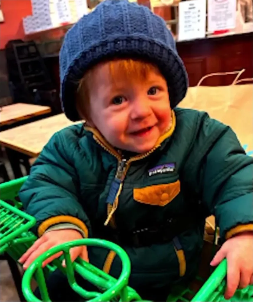 18-month-old Luke Russel Jr. sitting in a cart.