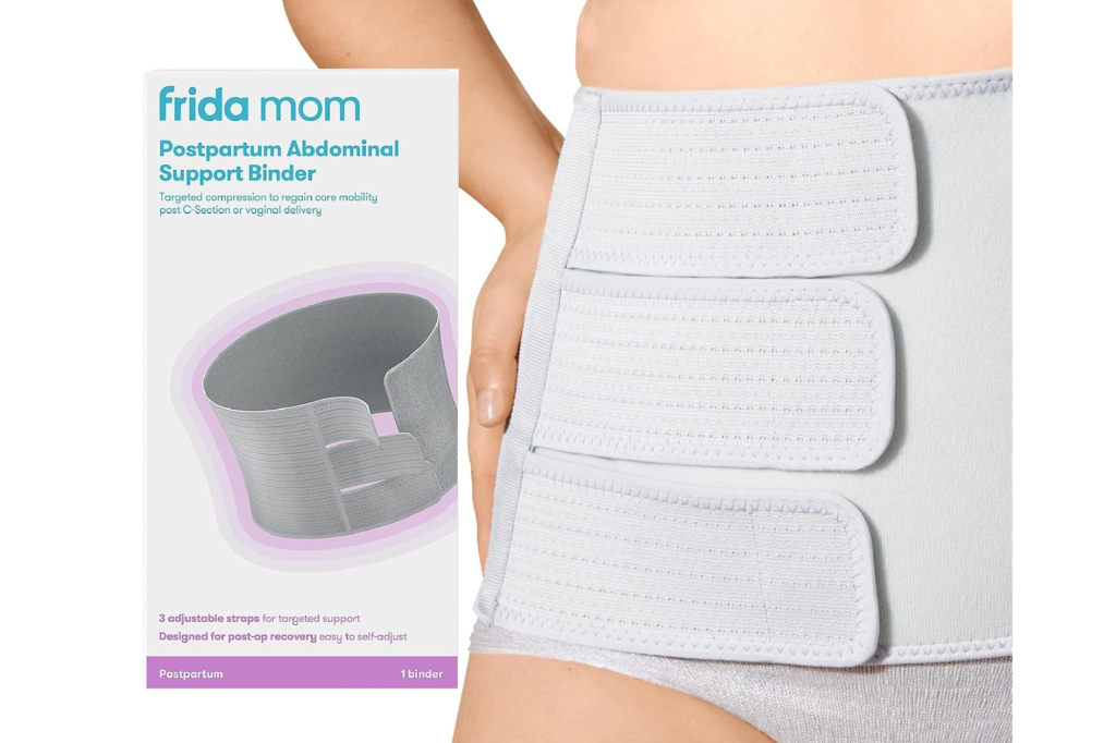 Frida Mom Postpartum Abdominal Support Binder packaging next to a person wearing the white binder.