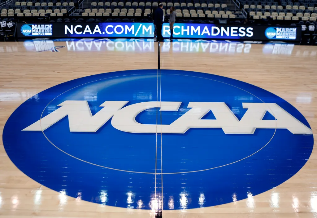 NCAA logo at center court in an arena.