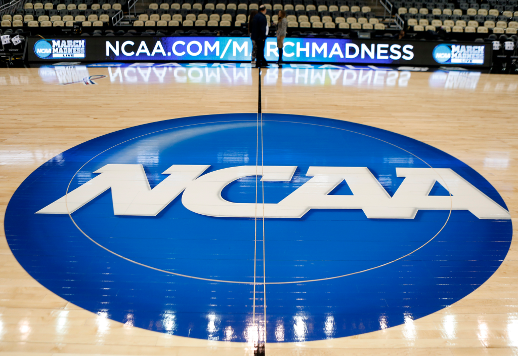 NCAA logo painted on a basketball court.