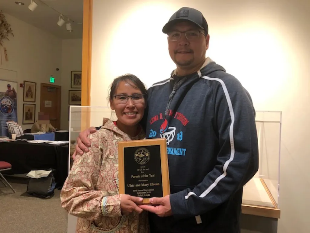 Mary and Ulrich Ulroan holding their "Parents of the Year" award.