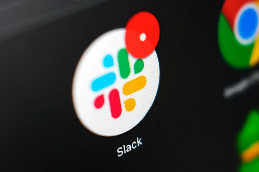 The Slack app icon is displayed on a computer screen.