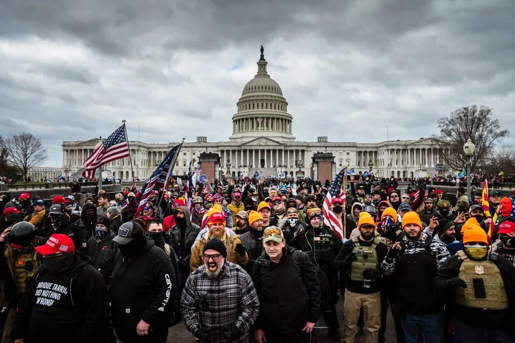 Pro-Trump protesters, including Proud Boys leader Joe Biggs, gather in front of the U.S. Capitol Building.