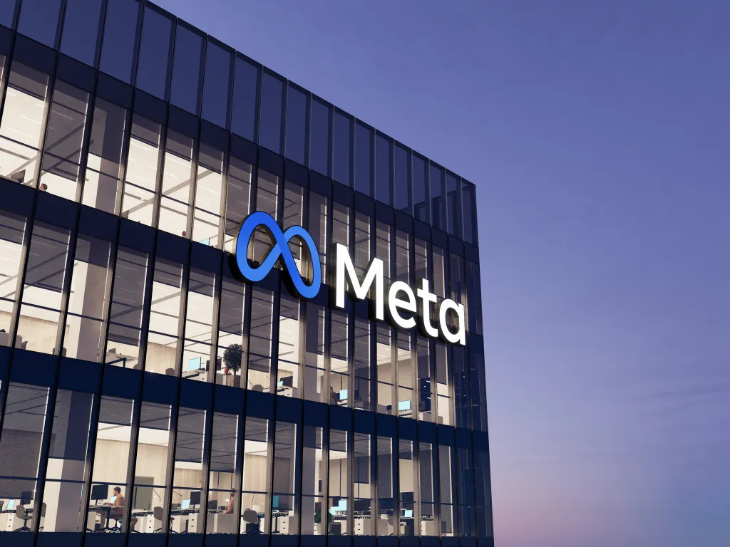 Illustration of the Meta logo on top of a glass building.