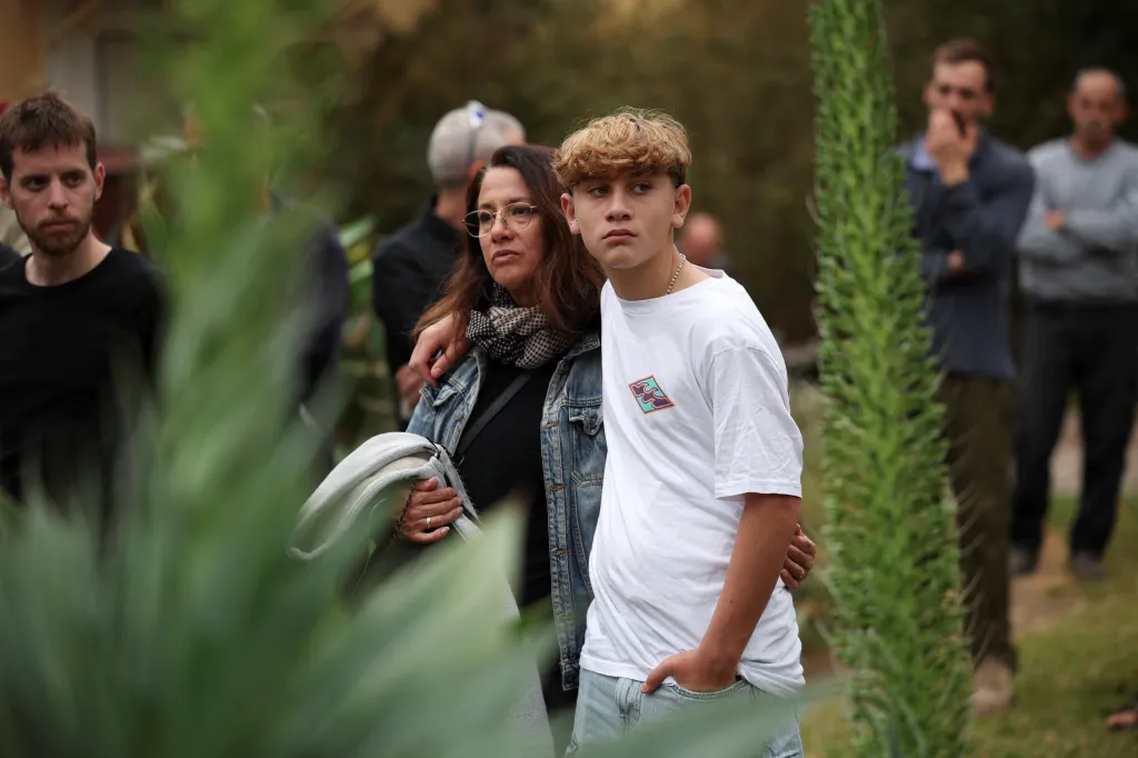 Yagil Yaakov, a former hostage, stands with his mother Renana Gome at a ceremony in Kibbutz Nir Oz.