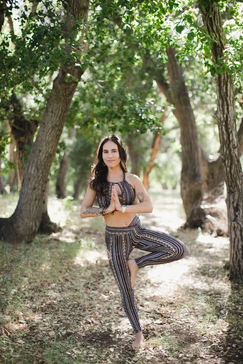 Ashley Phillips in a yoga tree pose outdoors.