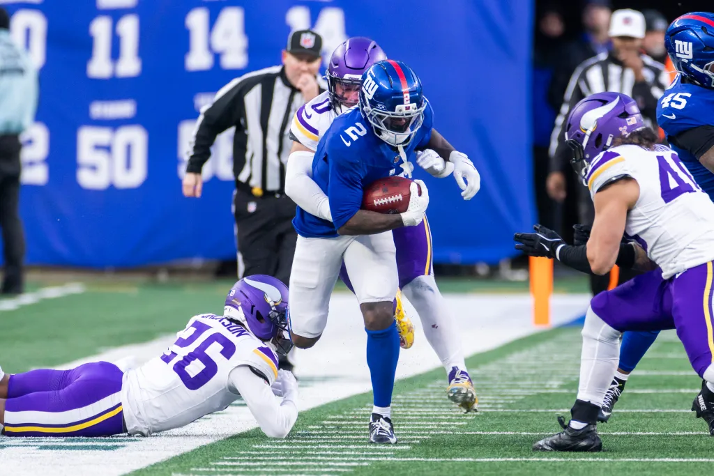 Cornerback Deonte Banks #2 of the New York Giants runs the ball as linebacker Ivan Pace Jr. #0 of the Minnesota Vikings tackles during the second half at MetLife Stadium, Sunday, Dec. 21, 2025, in East Rutherford, New Jersey. 