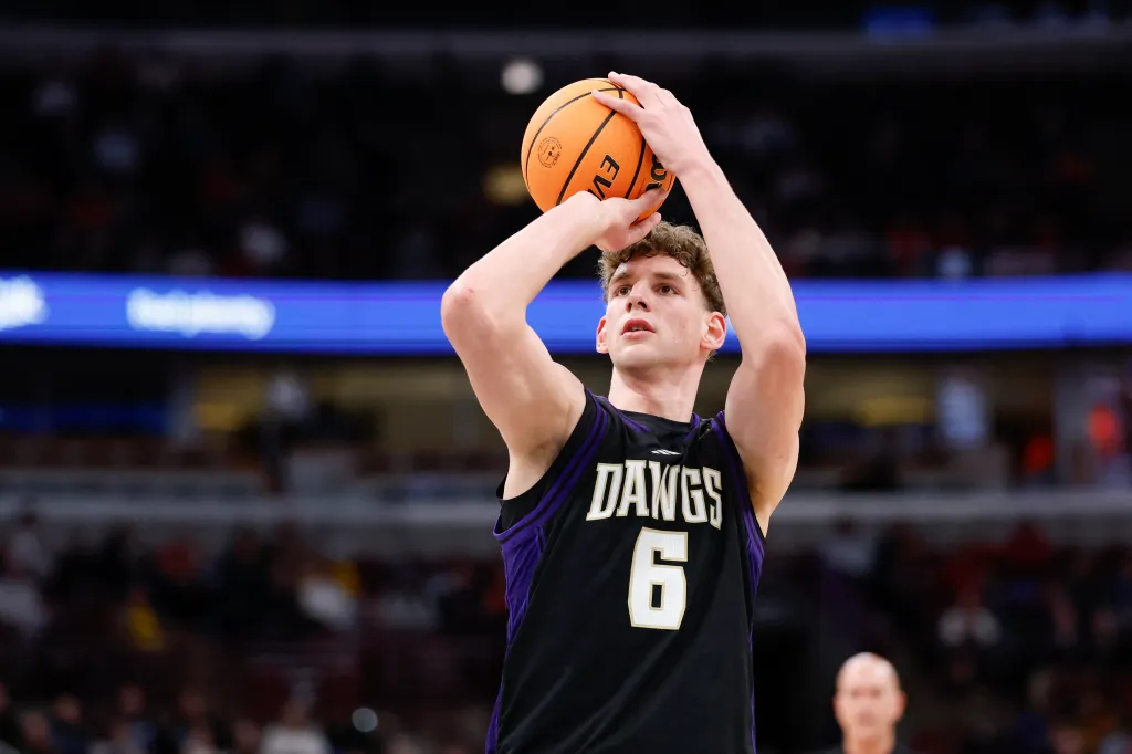 Basketball player in a black and purple jersey shooting a free throw.