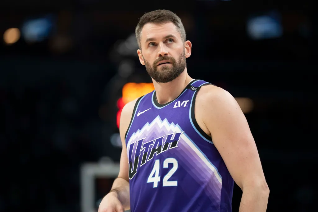 Basketball player in a purple Utah Jazz jersey with number 42.