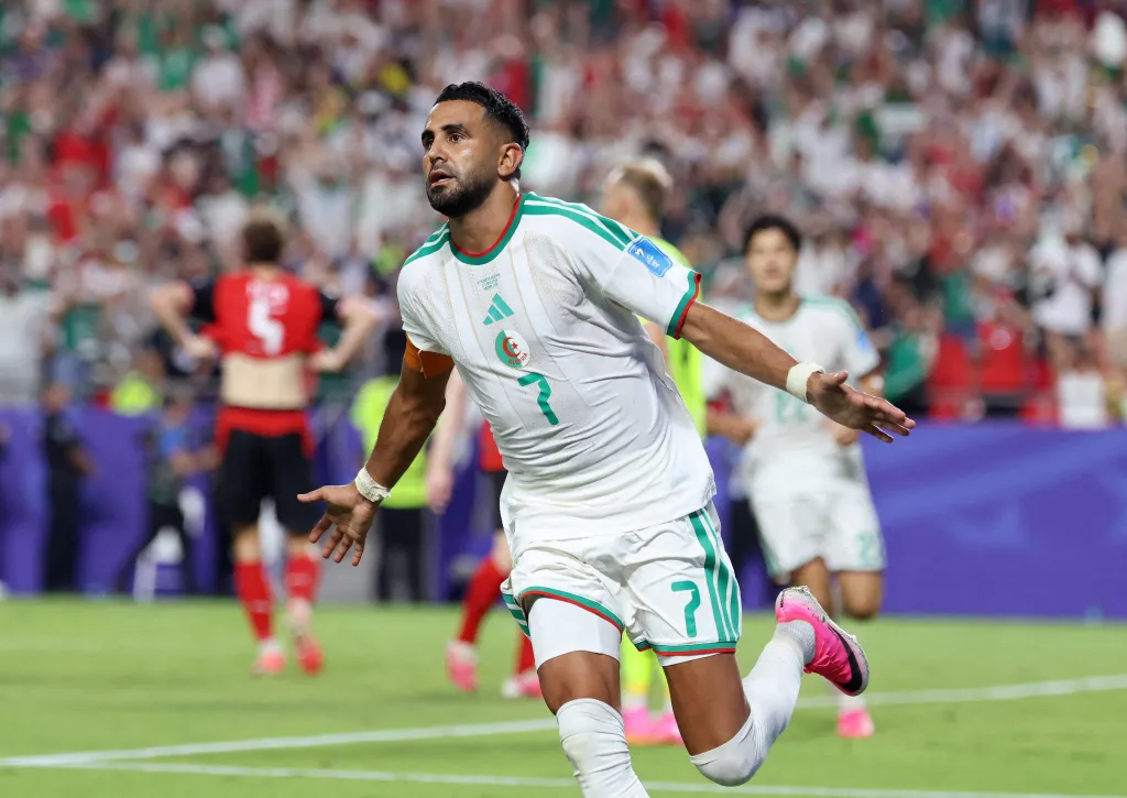 Algeria's Riyad Mahrez celebrating a goal in a soccer match.