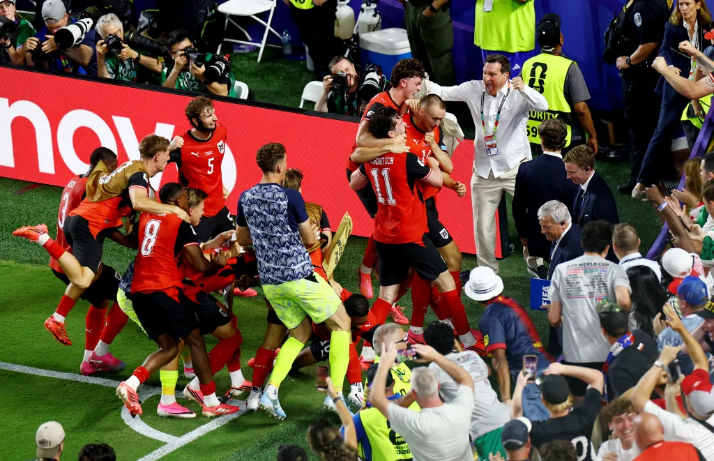 Austria's Saša Kalajdžić celebrates scoring their third goal with teammates during the FIFA World Cup 2026 match against Algeria.