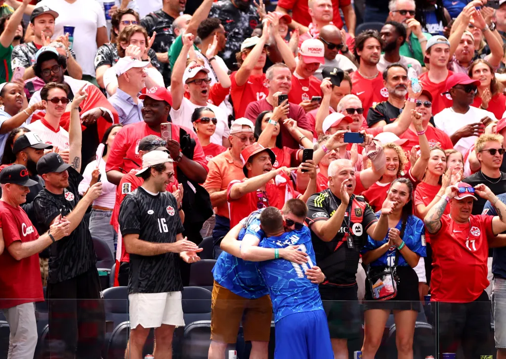 Canada's Maxime Crepeau celebrates with fans after the match.