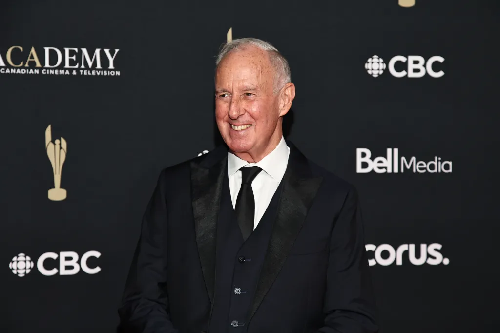 Ron MacLean smiling in a black suit with a black tie at the 2026 Canadian Screen Awards.