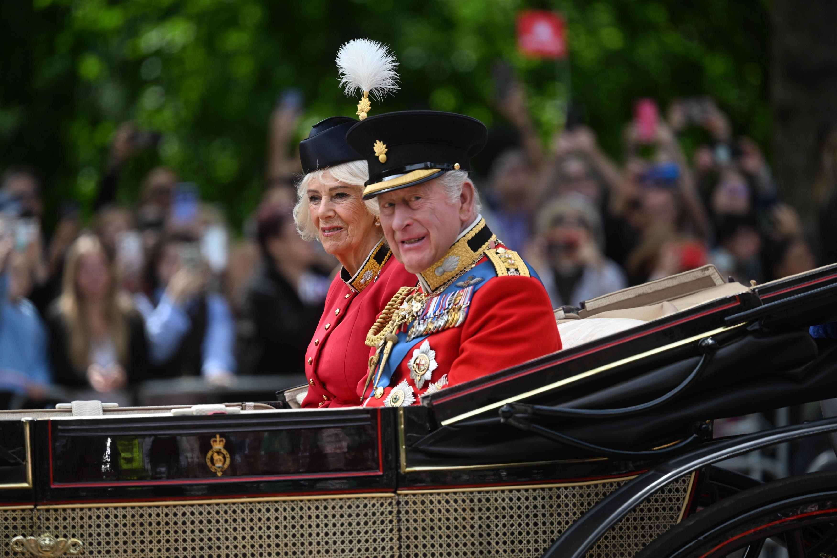 Queen Camilla and King Charles III pass through the Trooping The Colour parade.