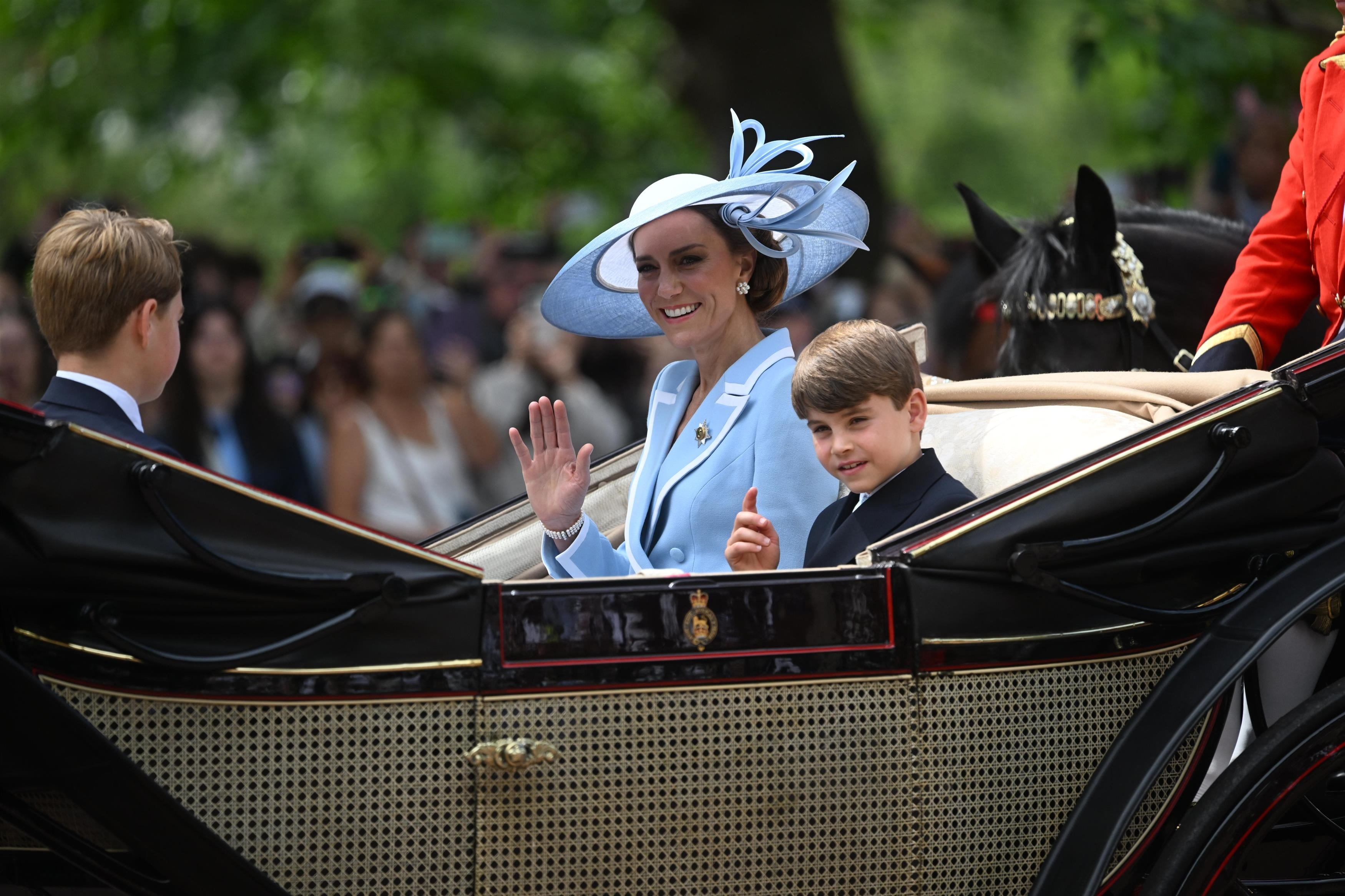 Catherine, Princess of Wales and Prince Louis wave during the Trooping the Colour parade.