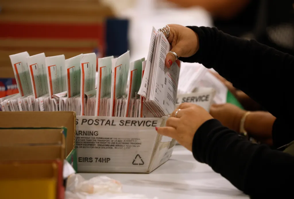 An election worker processing mail-in ballots.