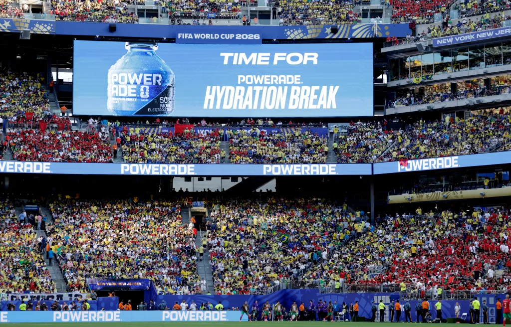 A large screen at the FIFA World Cup 2026 displays "TIME FOR POWERADE HYDRATION BREAK" to a stadium full of spectators.