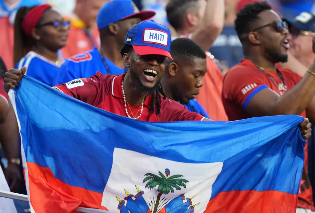 Haiti fans hold up a flag at the FIFA World Cup 2026 match against Scotland.