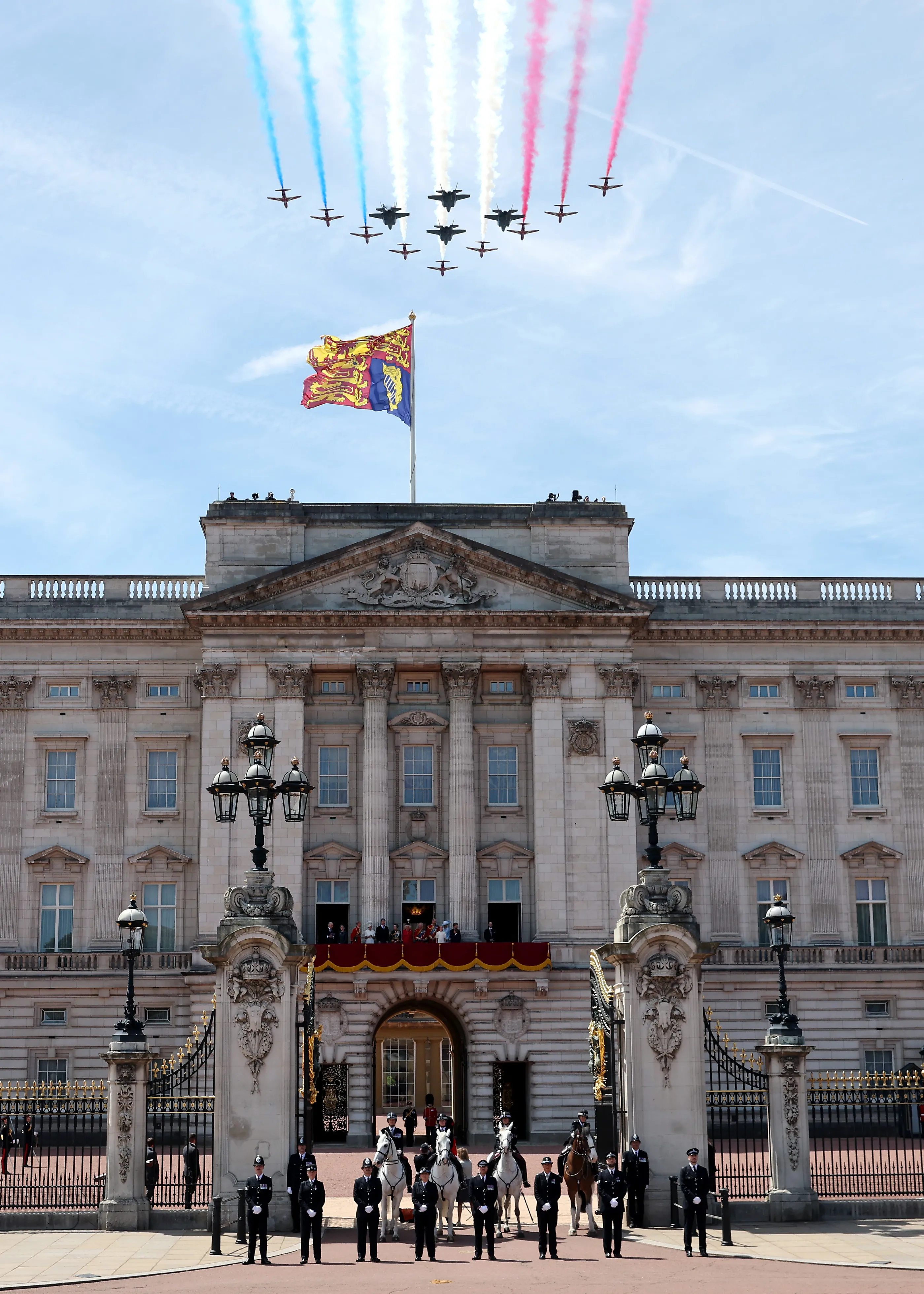 The Red Arrows perform a flypast over Buckingham Palace.
