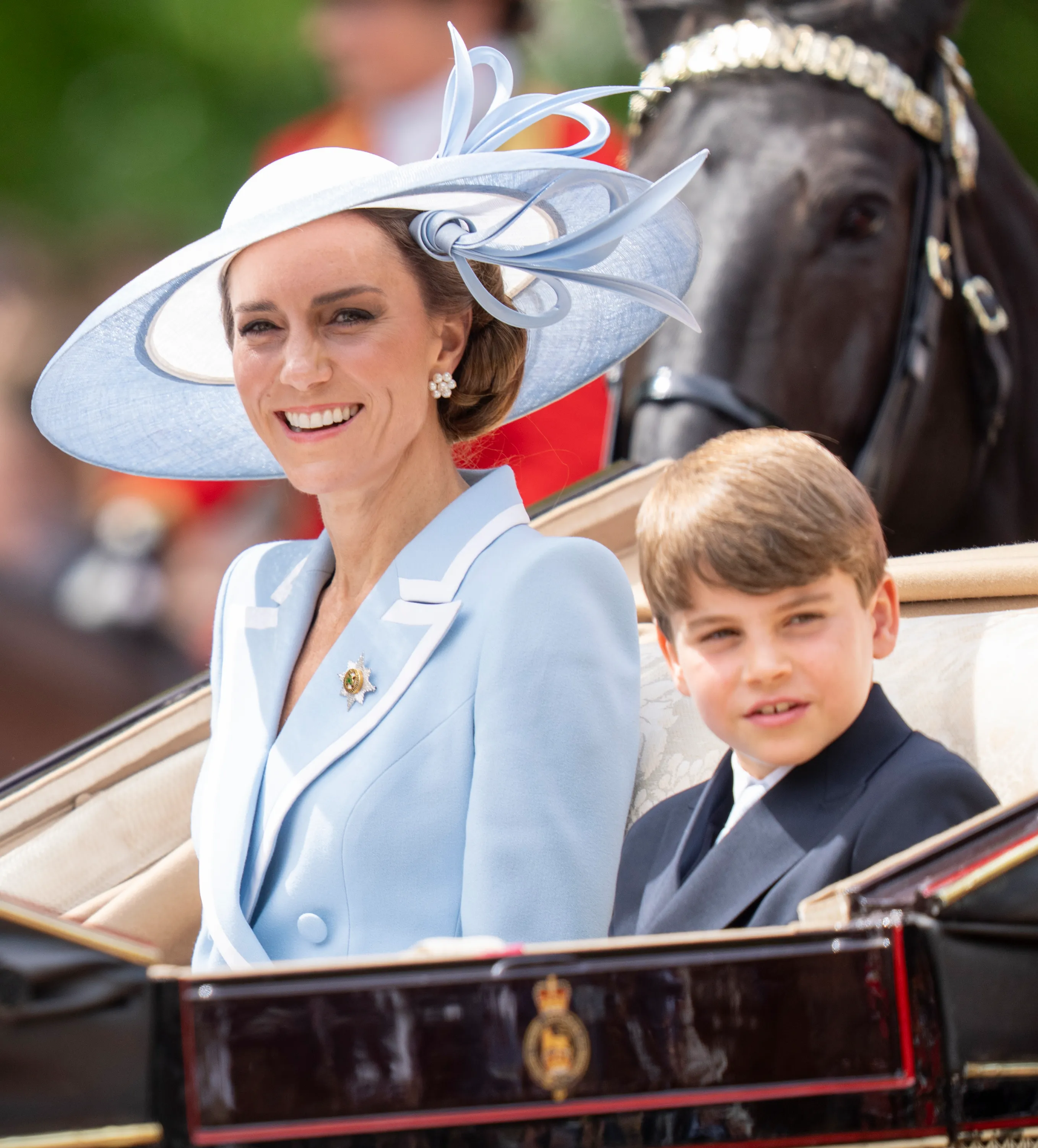 Catherine, Princess of Wales and Prince Louis of Wales pass through the Trooping The Colour parade.