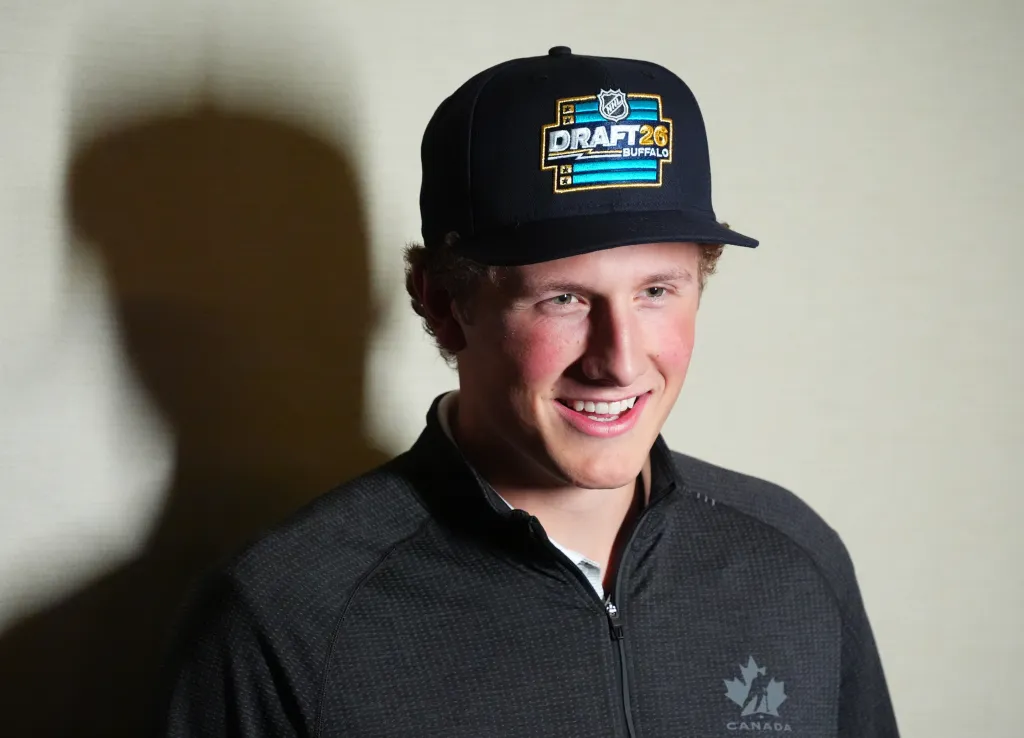 Keaton Verhoeff smiling, wearing a black cap with a "Draft '26 Buffalo" logo and a black Canada jacket.