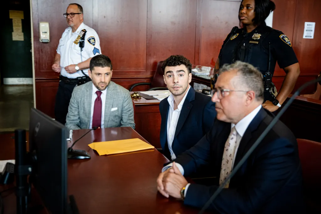Luigi Mangione, accused of murder, in court with his lawyers.