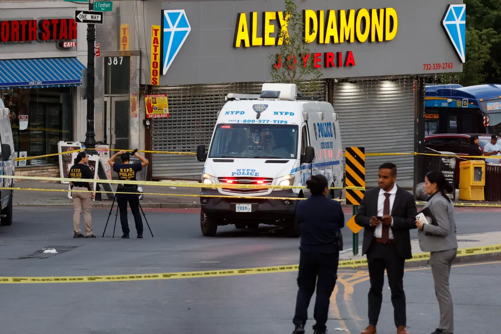 NYPD officers investigating a crime scene on East Fordham Road in the Bronx.
