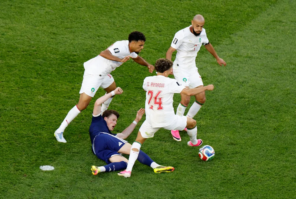 Scotland's Scott McTominay in action with Morocco's Chadi Riad, Neil El Aynaoui and Noussair Mazraoui during a match.