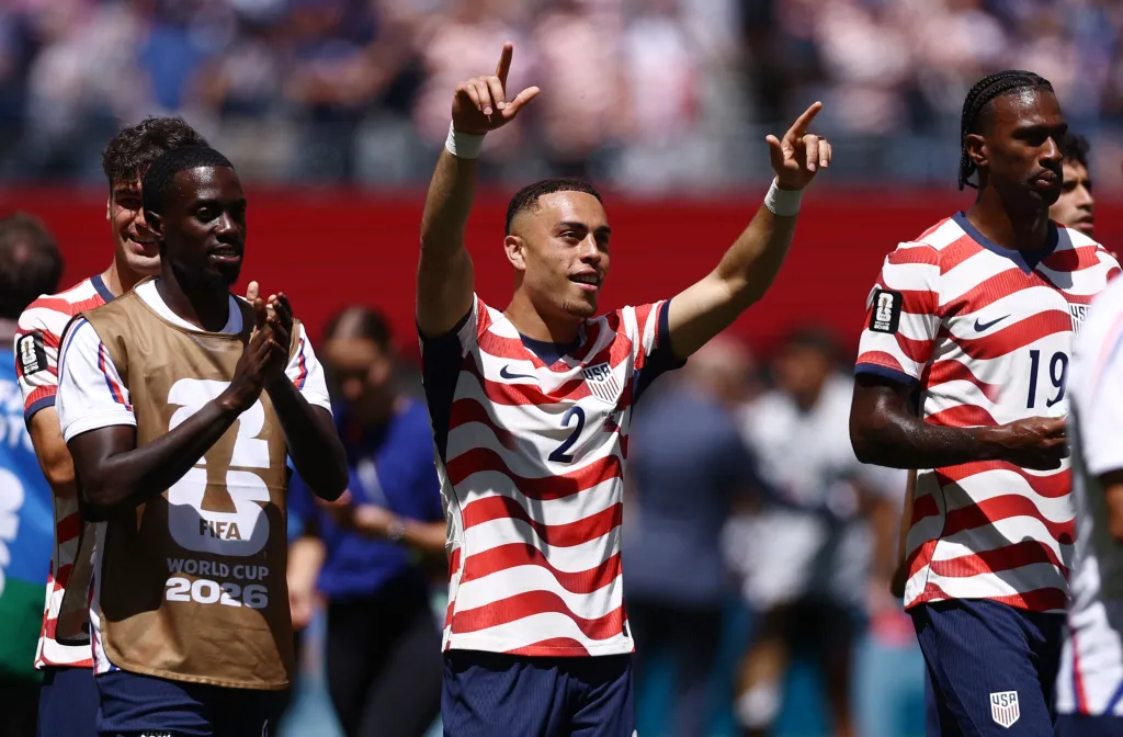 Sergino Dest of the U.S. celebrates with teammates after the match.