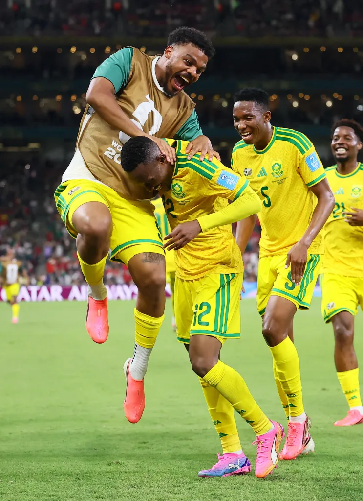 South Africa's Thapelo Maseko celebrates scoring with Lyle Foster and Thalente Mbatha.