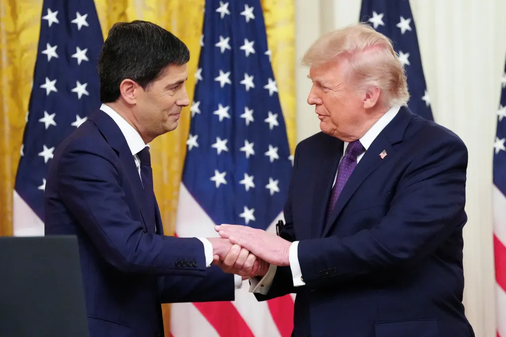 US President Donald Trump shakes hands with Federal Reserve Chairman Kevin Warsh.