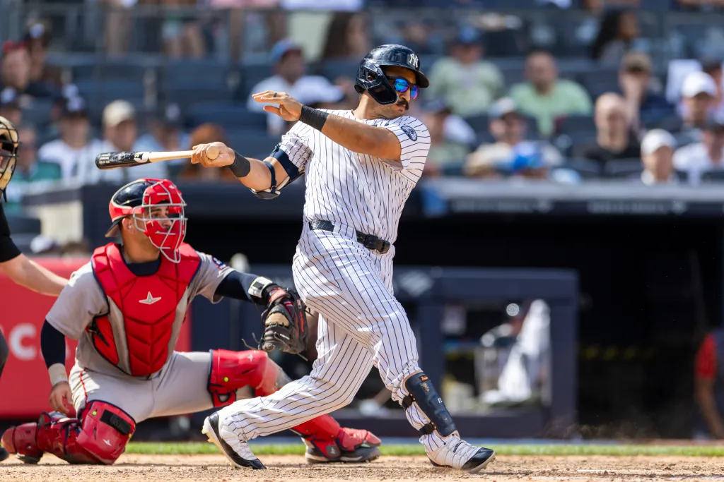 New York Yankees center fielder Trent Grisham (12) hits a RBI single driving home New York Yankees third baseman Amed Rosario (14) in the eighth inning against the Boston Red Sox at Yankee Stadium, Sunday, June 7, 2026, in Bronx, NY.