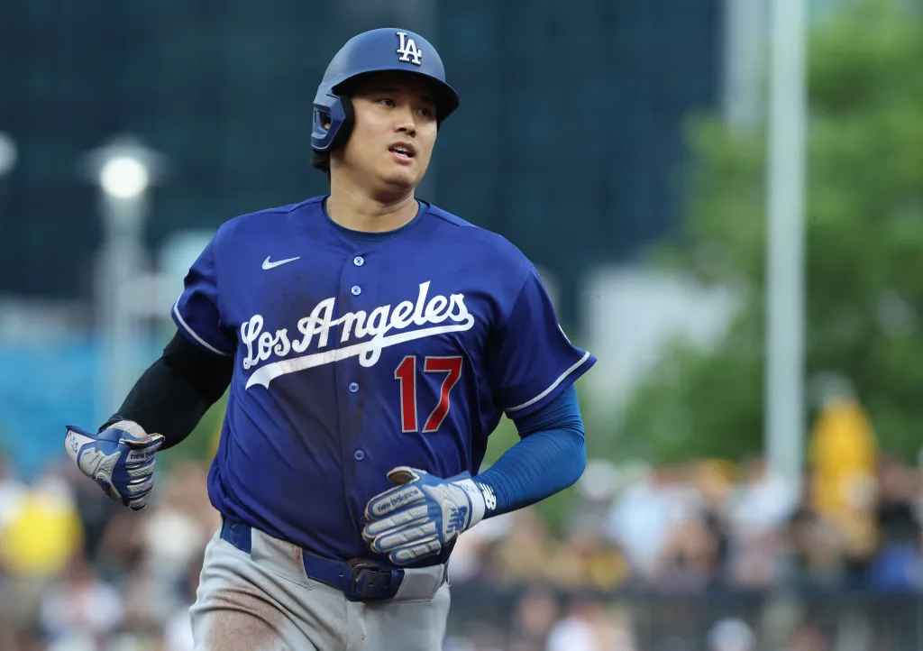 Shohei Ohtani of the Los Angeles Dodgers running on the field in a blue uniform with the number 17.