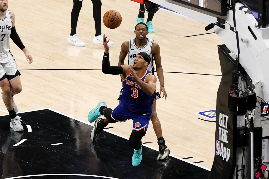 New York Knicks guard Josh Hart (3) and San Antonio Spurs guard De'aaron Fox (4) look for the ball during game five of the 2026 NBA Finals at Frost Bank Center.