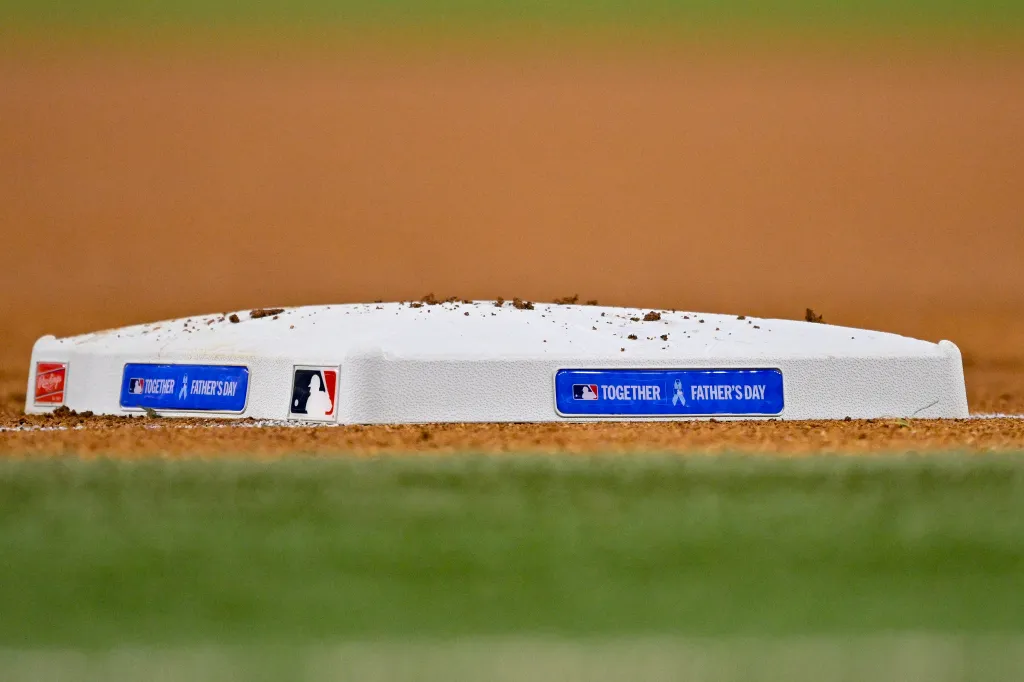 A baseball base with "Together Father's Day" written on it.