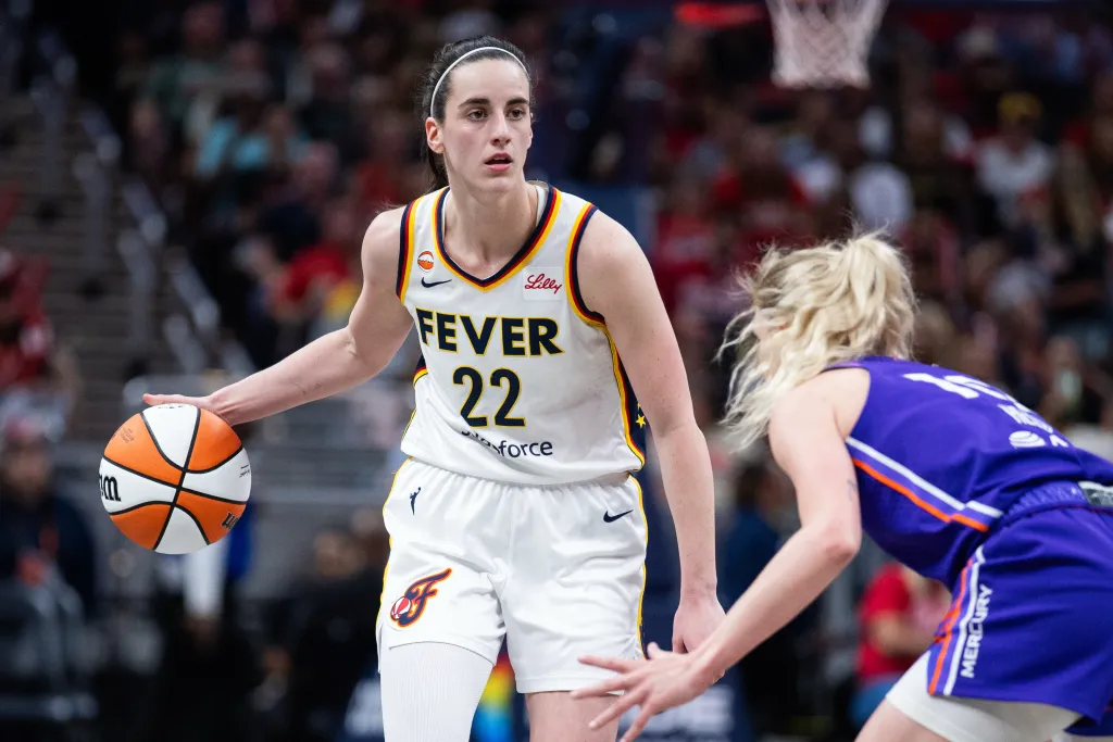 Jun 24, 2026; Indianapolis, Indiana, USA; Indiana Fever guard Caitlin Clark (22) dribbles the ball while Phoenix Mercury guard Lexi Held (10) defends in the second half at Gainbridge Fieldhouse.