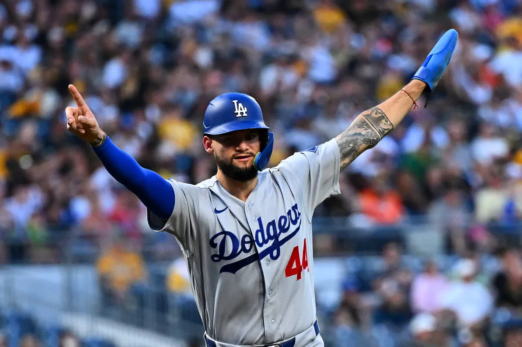 Dodgers outfielder Andy Pages raises his arms in celebration.