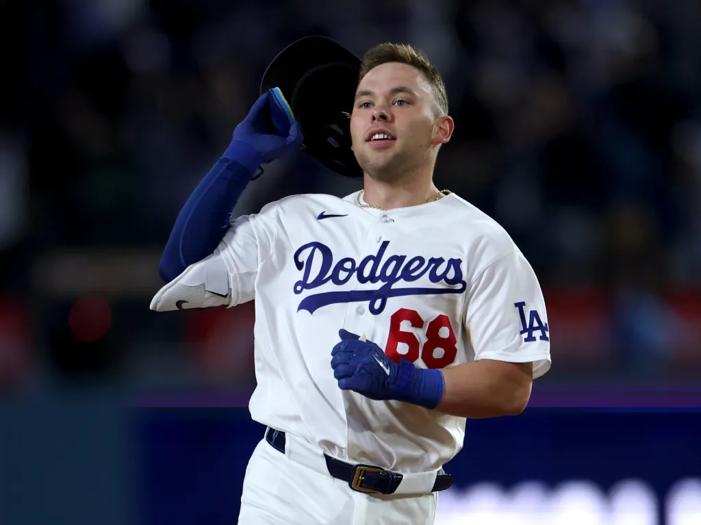 Los Angeles Dodgers player Michael Busch taking off his helmet.