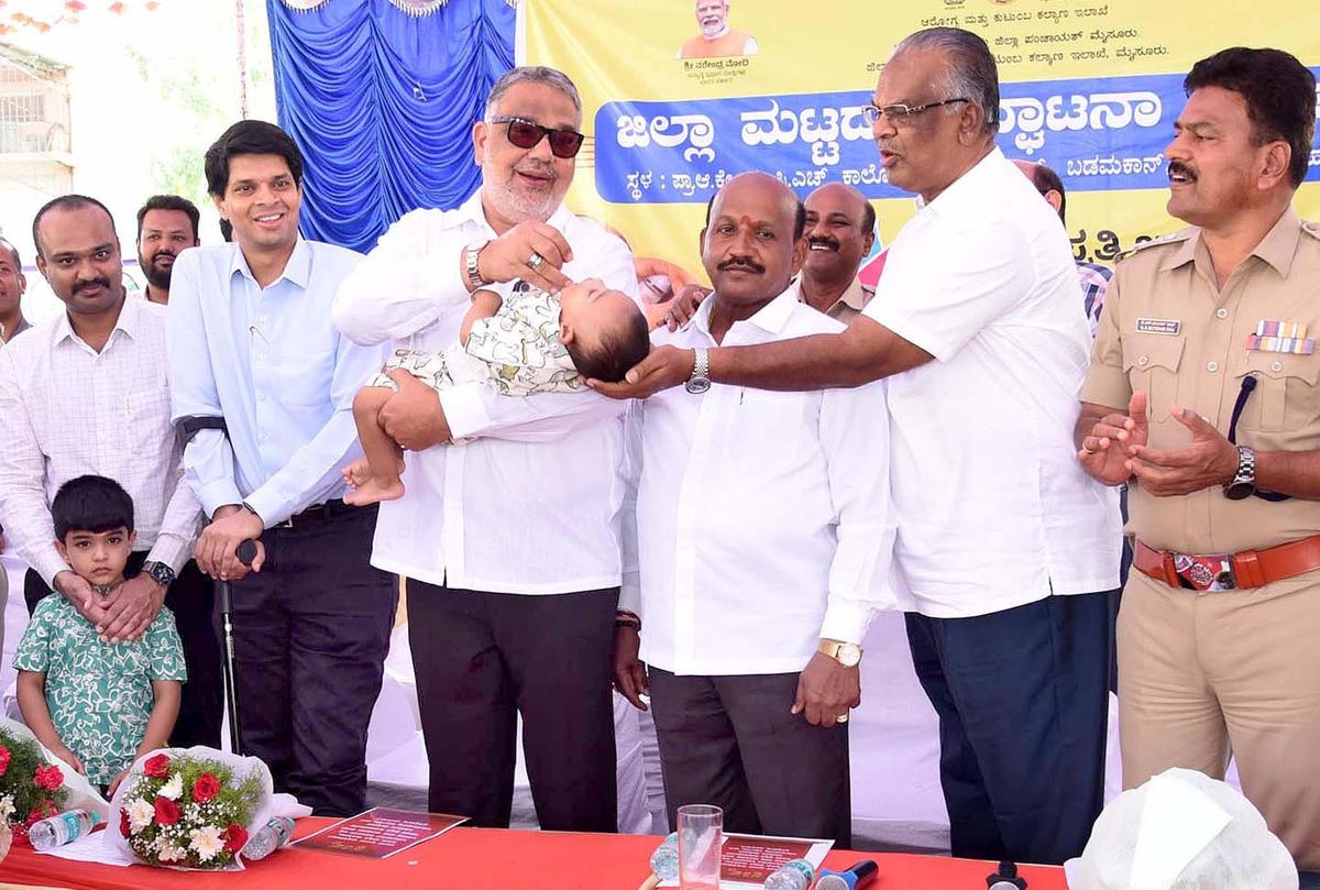 Tanveer Sait, MLA, administering oral polio drops to a child after launching the Pulse Polio immunisation campaign in Mysuru on Sunday (June 28).